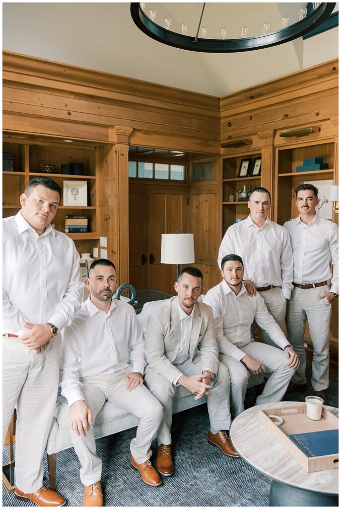 An indoor group photo of a groom with his groomsmen, wearing light linen suits for a hot summer wedding | Atlanta wedding photographer