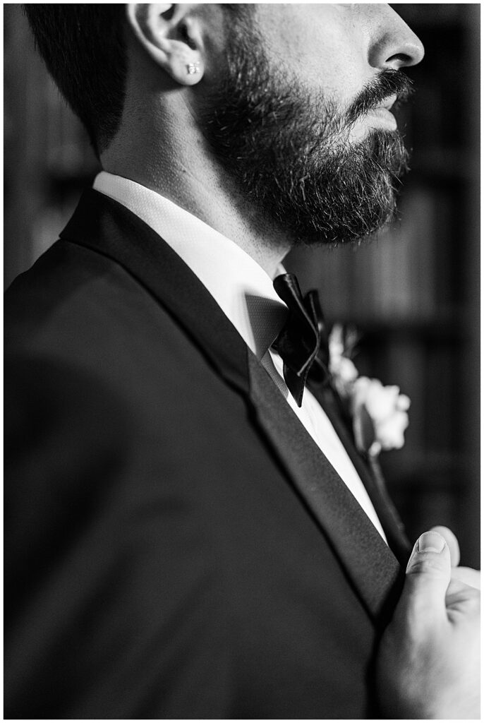 Must-have wedding photos | Atlanta wedding photographer | groom getting ready shot in black and white, closeup portrait angle of groom adjusting his jacket