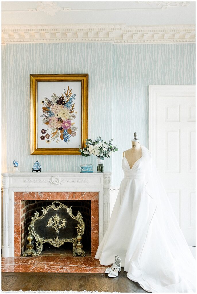 What is a fine art wedding photographer? | Atlanta fine art wedding photographer serving Georgia and beyond | Photo of a plunge neckline ballgown wedding dress on a dress form next to a French country style fireplace