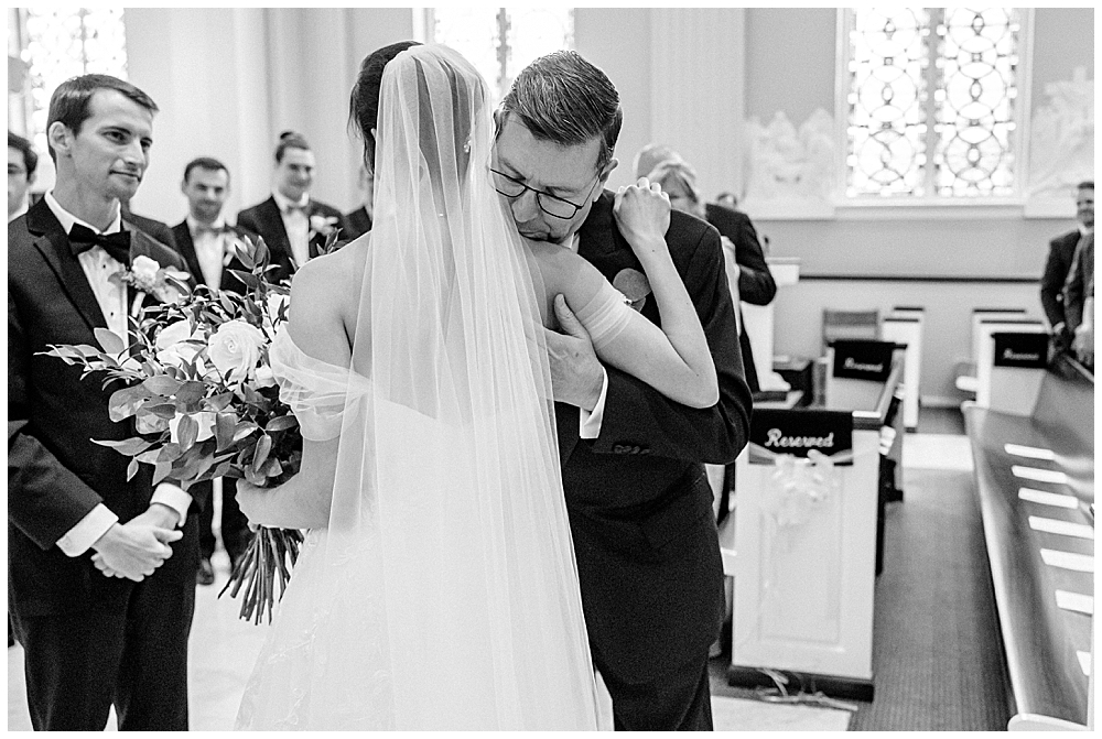 Fine Art Luxury Wedding Photographer in Atlanta | Bride hugging her father at wedding ceremony in a church